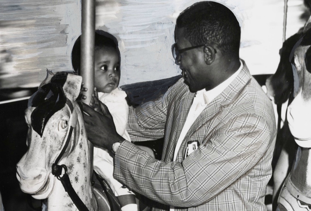 The Baltimore Sun photo of 11-month-old Sharon Langley and her father on the carousel at Gwynn Oak Amusement Park on Aug. 28, 1963, in Baltimore. (©Hearst Communications, Inc.)