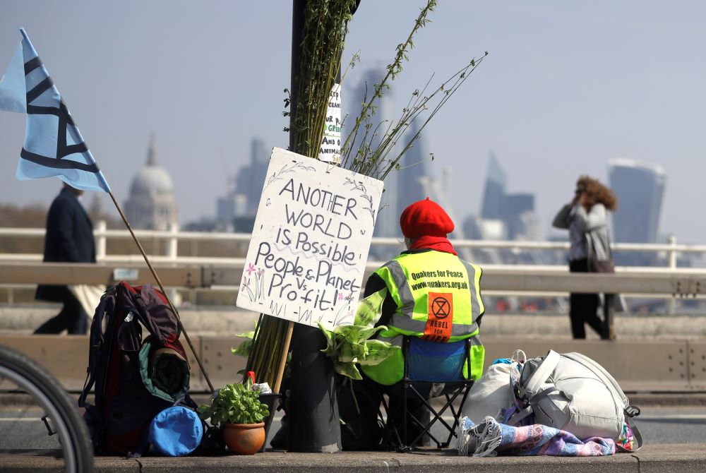 A demonstrator sits in the road during a climate protest organized by the environmental group Extinction Rebellion. The weeklong nationwide protest included this April 15, 2019, action on Waterloo Bridge in London.
