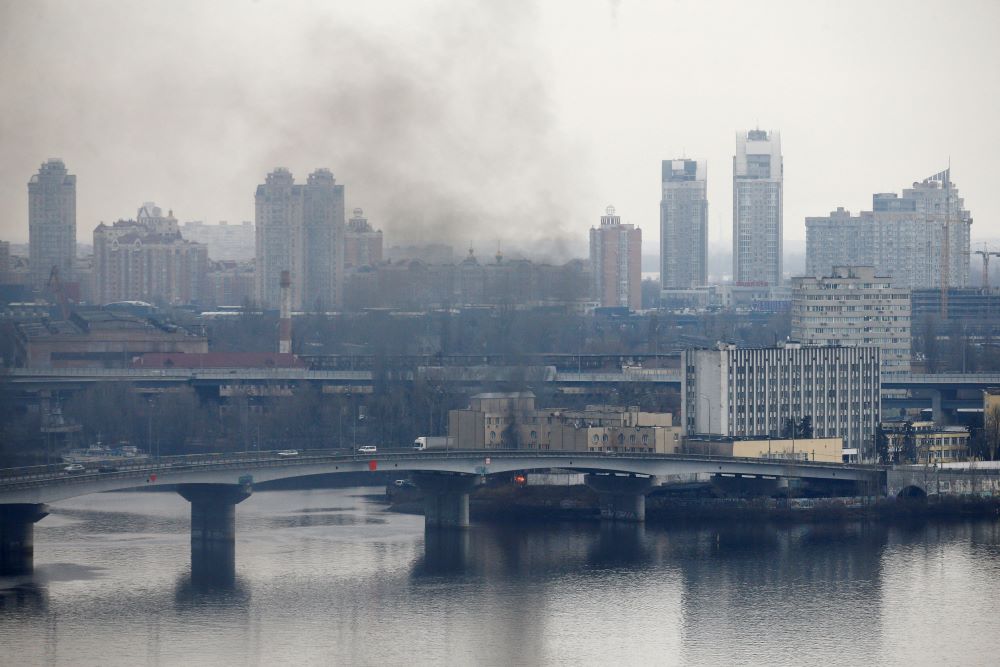 Smoke rises from the territory of the Ukrainian Defense Ministry's unit in Kyiv Feb. 24 after Russian President Vladimir Putin authorized a military operation in Ukraine. (CNS/Reuters/Valentyn Ogirenko)