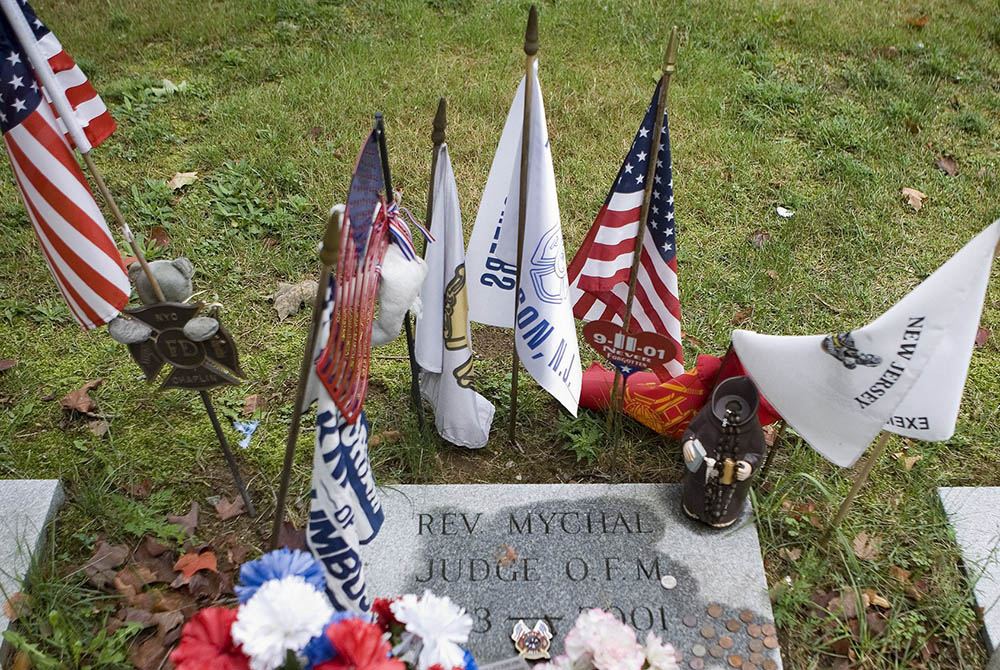 Flags around the grave of Fr. Mychal Judge Flags and other items surround the grave where Franciscan Father Mychal F. Judge, a chaplain of the New York Fire Department, is buried at Holy Sepulchre Cemetery in Totowa, New Jersey. Judge died in the Sept. 11, 2001, World Trade Center attacks. (CNS/O