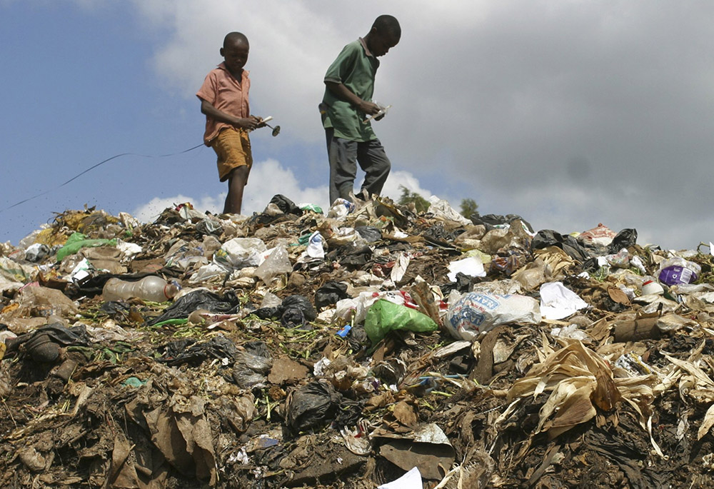 Children from a slum area scavenge through a garbage dump in Nairobi, Kenya, in late February 2009. (CNS/Reuters/Noor Khamis)