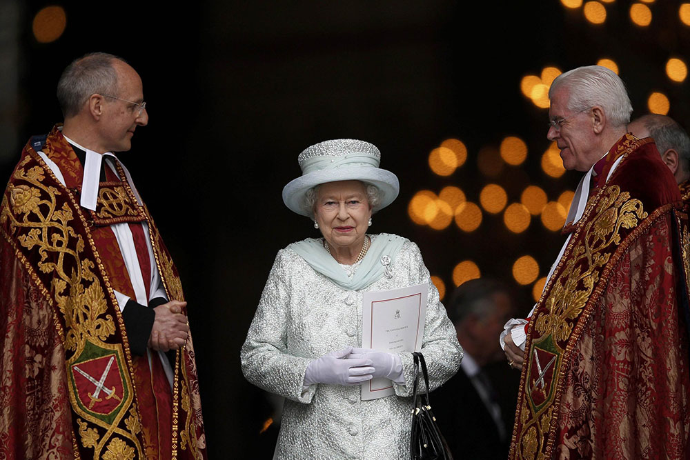 Britain's Queen Elizabeth II smiles as she leaves St. Paul's Cathedral in London with the Revs. David Ison and Michael Colclough following a thanksgiving service to mark her diamond jubilee in London June 5, 2012. (CNS/Reuters/Andrew Winning)