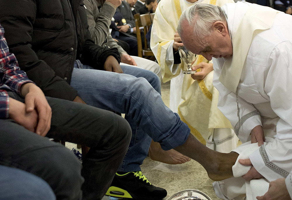 Pope Francis washes the foot of a prison inmate during the Holy Thursday Mass of the Lord's Supper at Rome's Casal del Marmo prison for minors March 28, 2013. (CNS/Reuters/L'Osservatore Romano)