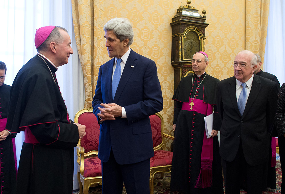 In January 2014, then-Cardinal-designate Pietro Parolin, Vatican secretary of state, meets with his U.S. counterpart in the Obama administration, John Kerry, at the Vatican. At right is Ken Hackett, then U.S. ambassador to the Holy See. (CNS) In January 2014, then-Cardinal-designate Pietro Parolin, Vatican secretary of state, meets with his U.S. counterpart in the Obama administration, John Kerry, at the Vatican. At right is Ken Hackett, then U.S. ambassador to the Holy See. (CNS)
