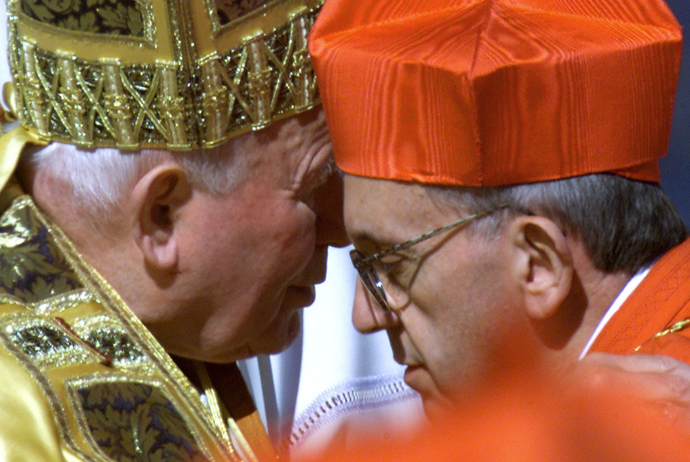 Pope John Paul II embraces Argentine Cardinal Jorge Bergoglio after presenting the new cardinal with a red beretta at the Vatican Feb. 21, 2001, setting the stage for the Bergoglio's later election as Pope Francis. (CNS/Reuters)