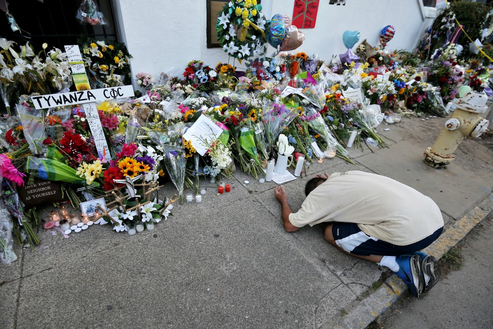 A man pays his respects outside Emanuel African Methodist Episcopal Church in Charleston, South Carolina, June 21, 2015. Nine African-Americans were shot to death by Dylann Roof at an evening Bible study inside the church June 17, 2015. (CNS/Brian Snyder)