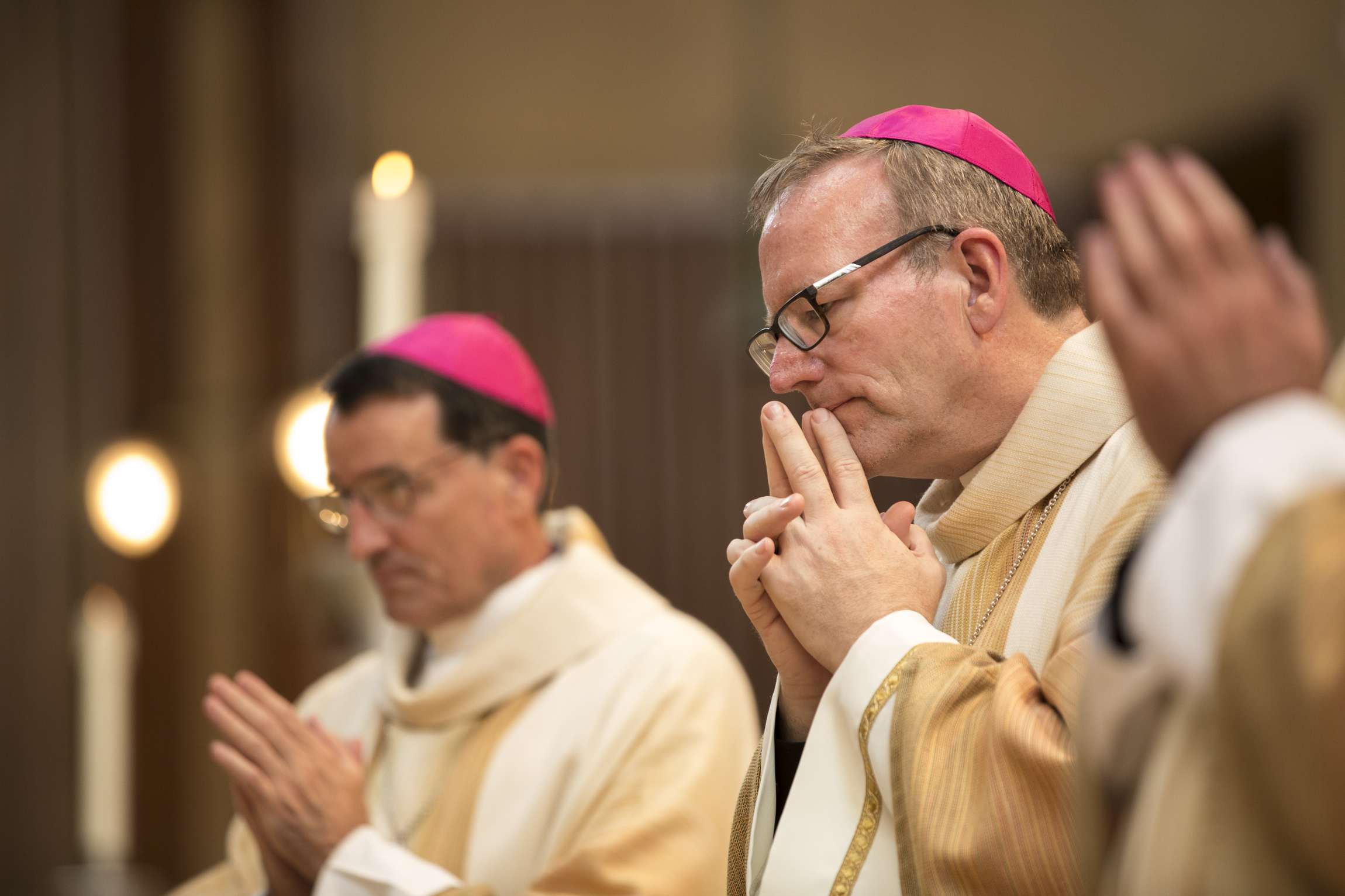 Auxiliary Bishops Joseph Brennan and Robert Barron pray during their Sept. 8, 2015, episcopal ordination at the Cathedral of Our Lady of the Angels in Los Angeles. Not pictured is Auxiliary Bishop David O'Connell, who was also ordained. (CNS)