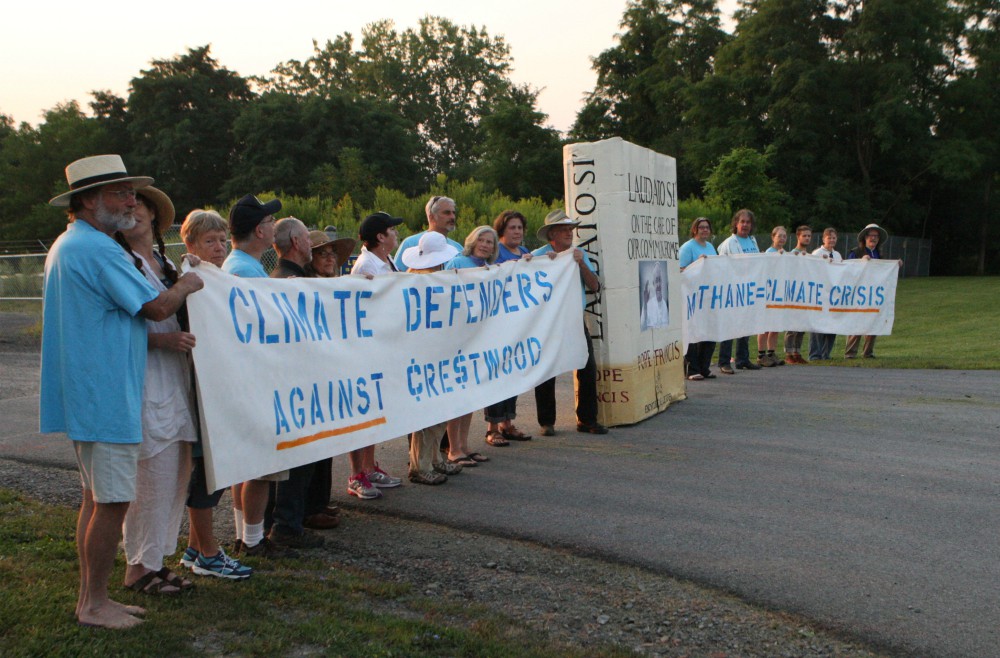 A line of protesters Aug. 18, 2015, blocks the main gate at the Crestwood Midstream Partners gas storage facility on the shores of Seneca Lake in Reading, New York. Eighteen people were arrested while reading Pope Francis' encyclical Laudato Si'. (CNS)