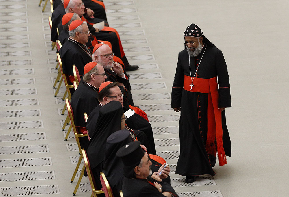 Cardinals Baselios Cleemis Thottunkal of Trivandrum, India, major archbishop of the Syro-Malankara Catholic Church, walks to his seat during an event marking the 50th anniversary of the Synod of Bishops in Paul VI hall at the Vatican Oct. 17, 2015. (CNS)
