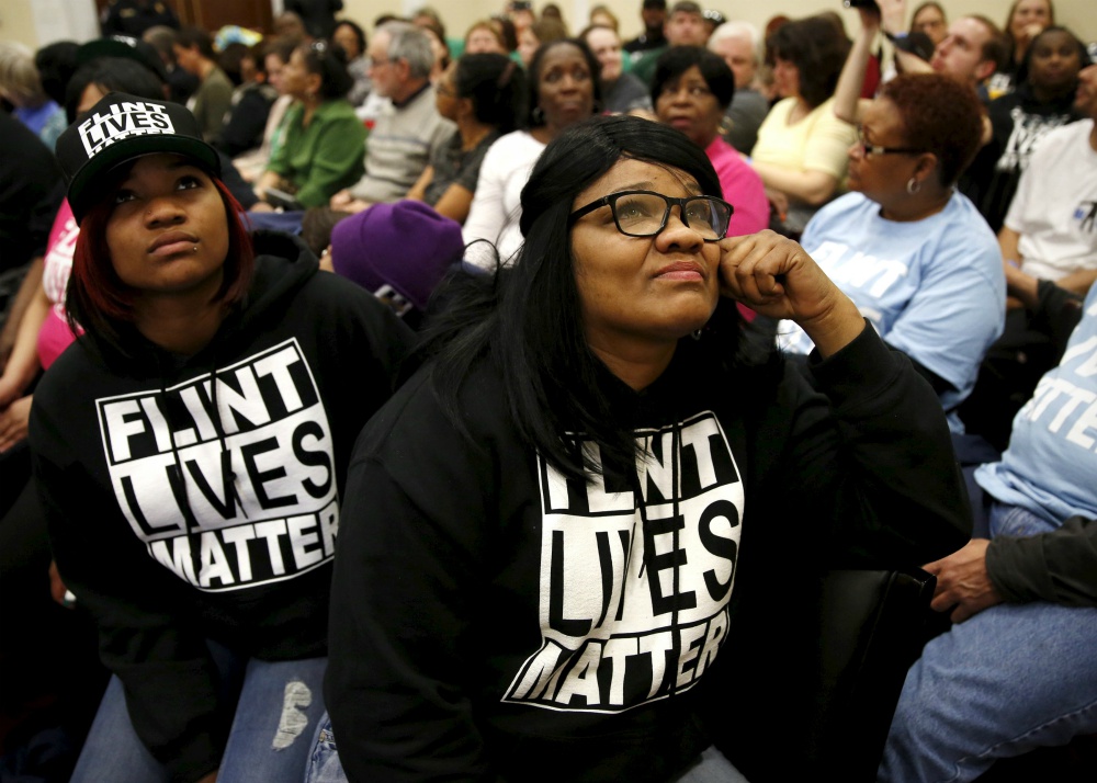 Residents of Flint, Michigan, watch a live feed of then-Gov. Rick Snyder and then-Environmental Protection Agency administrator Gina McCarthy testify March 17, 2016, in Washington at House hearing on the water crisis in Flint. (CNS/Reuters/Kevin Lamarque)