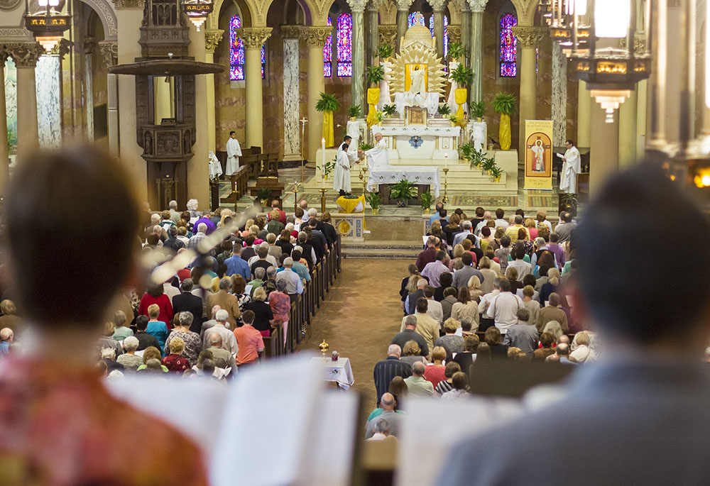 People pray during Mass April 17, 2016, at Holy Redeemer Church in Detroit. The Mass was the site of a "Mass Mob" event, an evangelization effort aimed at boosting regular Mass attendance. (CNS/Jim West)