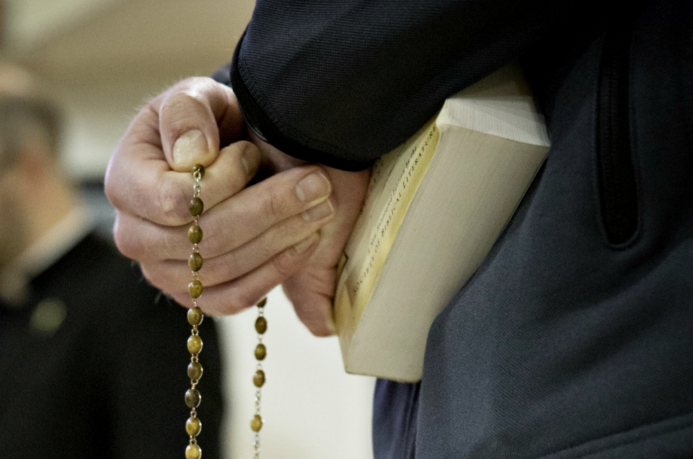 A seminarian from St. John's Seminary in Brighton, Massachusetts, holds a rosary before a discussion with a youth group in 2016. (CNS/Chaz Muth) A seminarian from St. John's Seminary in Brighton, Massachusetts, holds a rosary before a discussion with a youth group in 2016. (CNS/Chaz Muth)