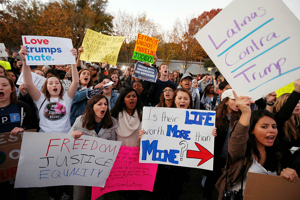Demonstrators shout and hold signs in front of the White House in Washington Nov. 10, 2016, following President-elect Donald Trump's victory in the Nov. 8 election. (CNS/Reuters/Kevin Lamarque) Demonstrators shout and hold signs in front of the White House in Washington Nov. 10, 2016, following President-elect Donald Trump's victory in the Nov. 8 election. (CNS/Reuters/Kevin Lamarque)