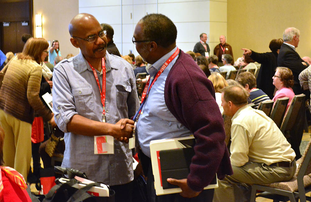 Synod members greet one another Nov. 18, 2016, during the opening session of the Detroit Archdiocese's synod. (CNS/The Michigan Catholic/Mike Stechschulte)