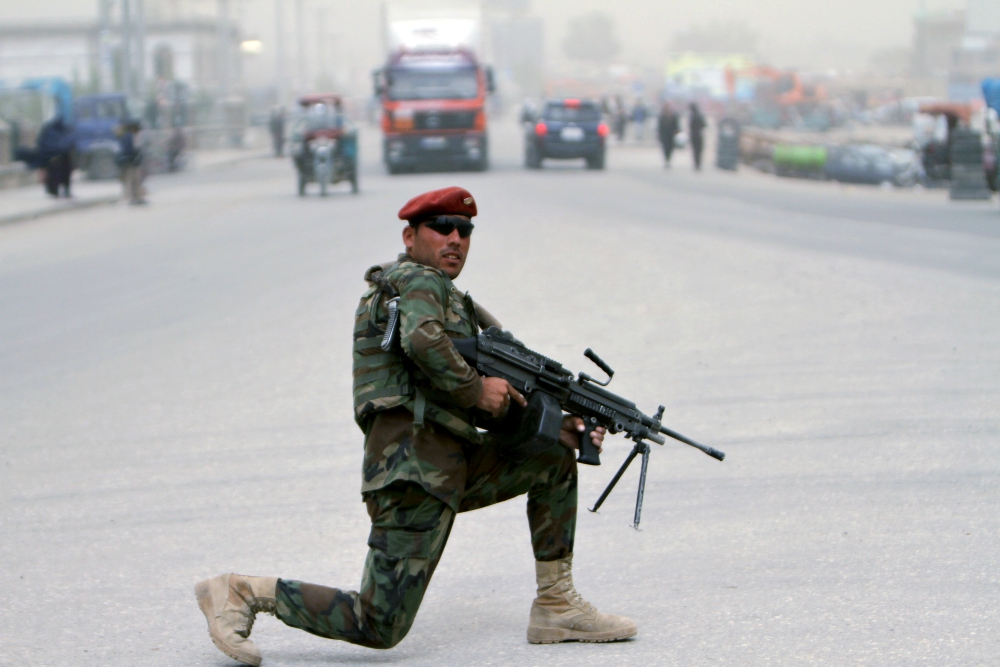 An Afghan soldier stands guard on a roadside in Ghazni, Afghanistan, April 22. (CNS/EPA/Ghulam Mustafa)