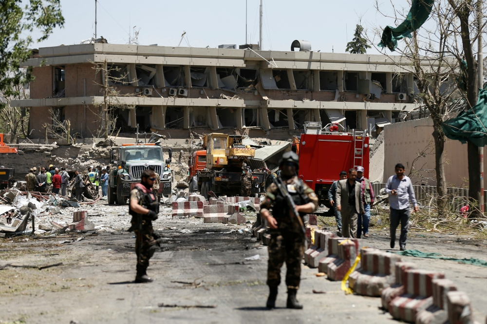 Afghan officials inspect outside the German embassy after a May 31 bombing in Kabul. At least 90 people were killed and more than 400 were wounded in one of the worst extremist attacks since the drawdown of foreign forces in 2014.