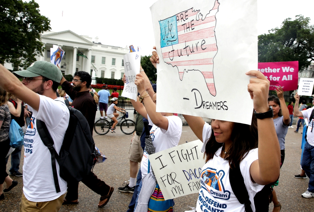 People march outside the White House Aug. 15 at a rally calling on President Donald Trump to protect the Deferred Action for Childhood Arrivals program, known as DACA. (CNS/Reuters/Joshua Roberts)