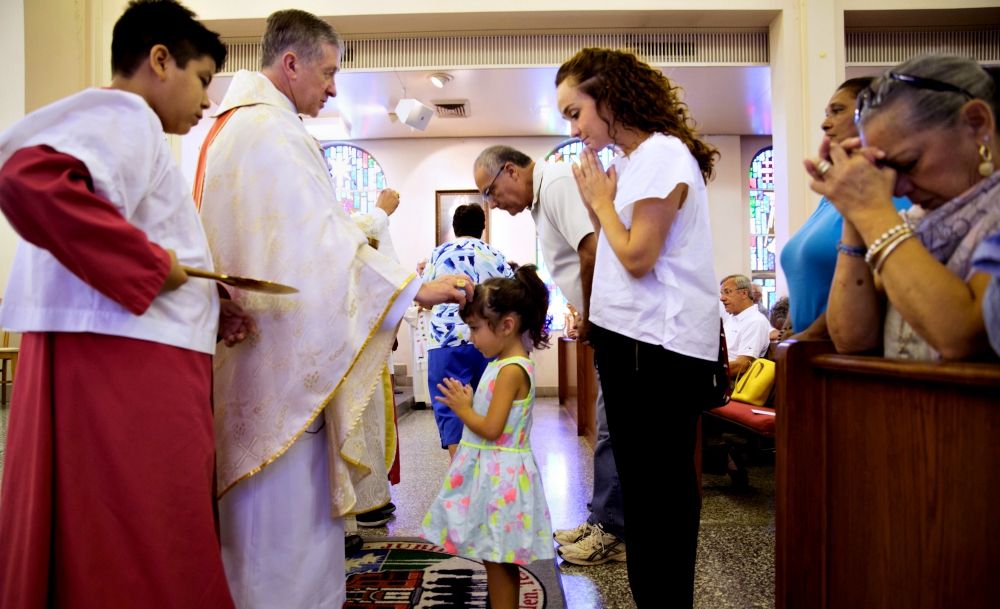 Chicago Cardinal Blase Cupich gives Communion during Mass at Sacred Heart Church in McAllen, Texas, Aug. 15. (CNS/Courtesy of Catholic Extension)