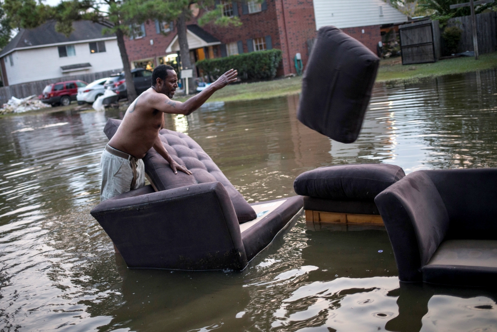 A man moves his flood-damaged sofas in Houston Sept. 3. (CNS/Reuters/Adrees Latif)
