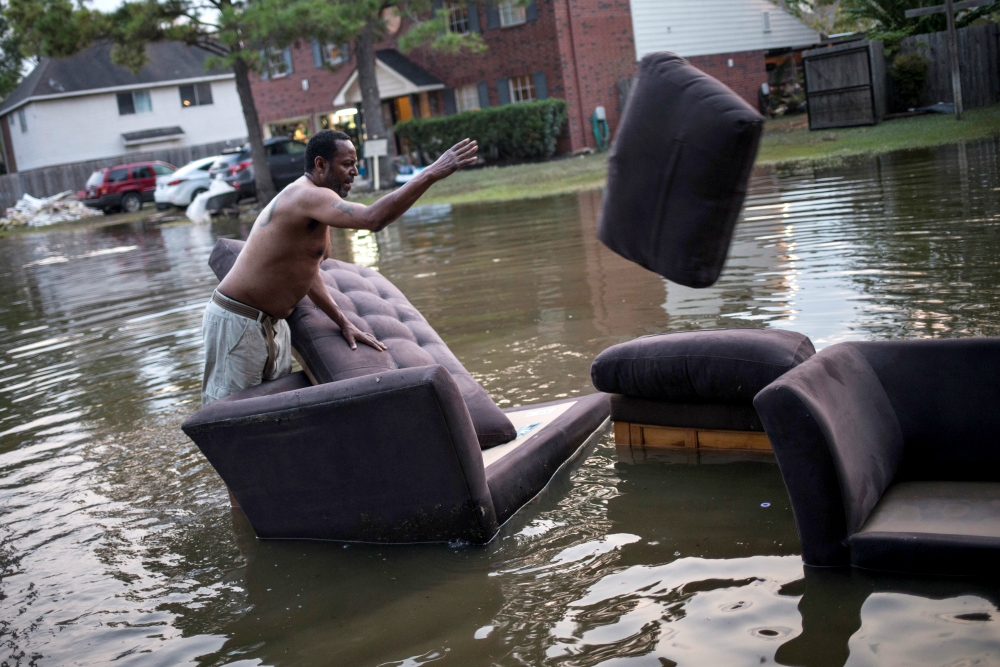 A man moves his flood-damaged sofas in Houston Sept. 3. (CNS/Reuters/Adrees Latif) A man moves his flood-damaged sofas in Houston Sept. 3. (CNS/Reuters/Adrees Latif)