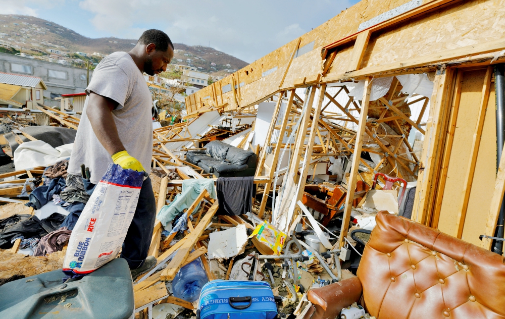 A man looks through the debris of his destroyed home in the aftermath of Hurricane Irma Sept. 17 in St. Thomas in the U.S. Virgin Islands. (CNS/Reuters/Jonathan Drake)