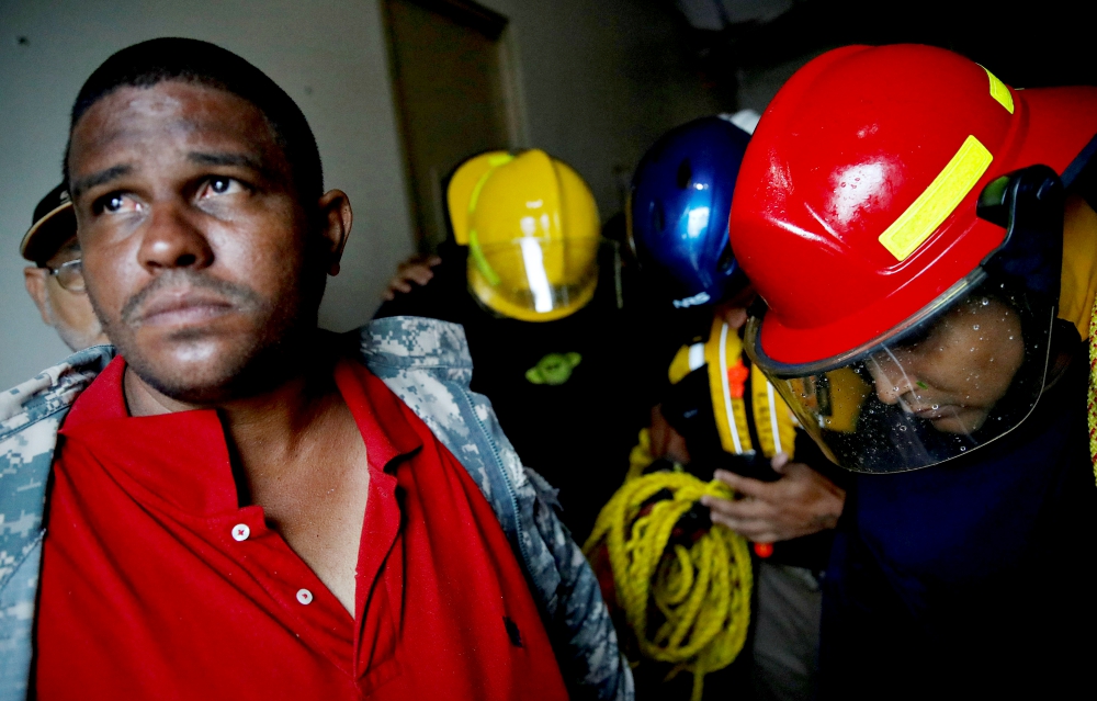 Rescue workers pray before walking out from the Emergency Operation Center in Guayama, Puerto Rico, after Hurricane Maria hit Sept. 20. (CNS/Reuters/Carlos Garcia Rawlins) Rescue workers pray before walking out from the Emergency Operation Center in Guayama, Puerto Rico, after Hurricane Maria hit Sept. 20. (CNS/Reuters/Carlos Garcia Rawlins)