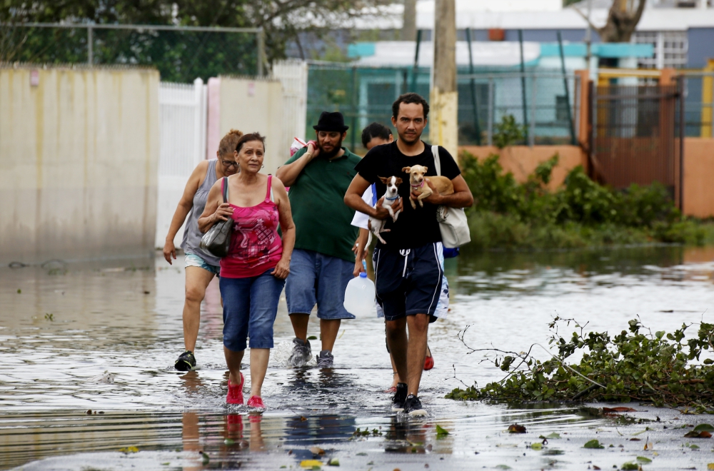 People walk in a flooded street Sept. 21 in Toa Baja, Puerto Rico, in the aftermath of Hurricane Maria. (CNS/EPA/Thais Llorca) People walk in a flooded street Sept. 21 in Toa Baja, Puerto Rico, in the aftermath of Hurricane Maria. (CNS/EPA/Thais Llorca)