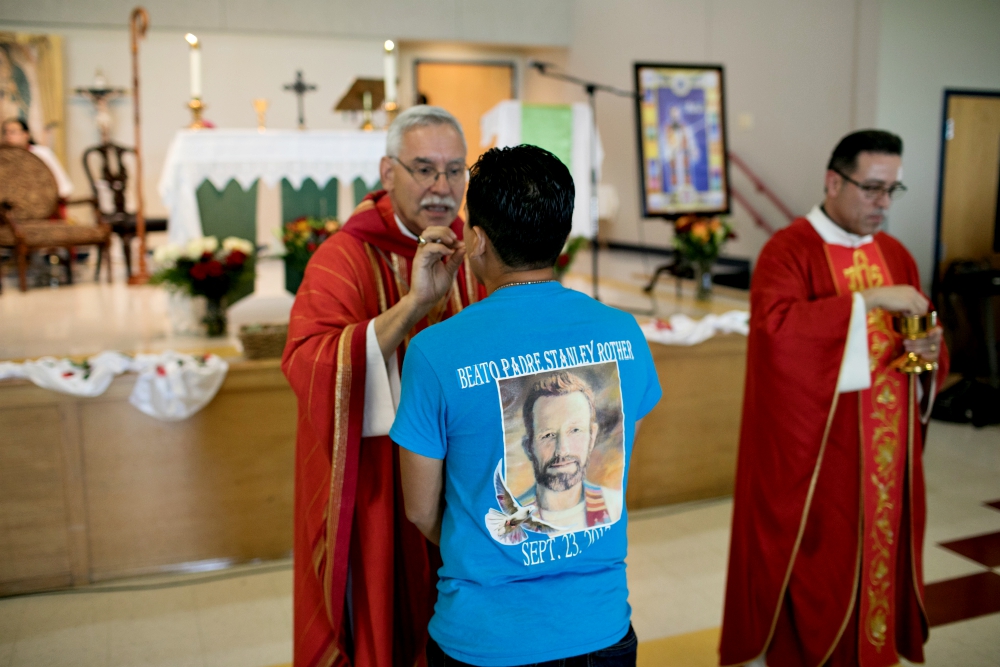 Bishop Anthony Taylor of Little Rock, Arkansas, gives Communion Sept. 24, 2017, to a member of a new Catholic community in Decatur named for Blessed Stanley Rother. (CNS/Courtesy of Catholic Extension/Rich Kalonick)