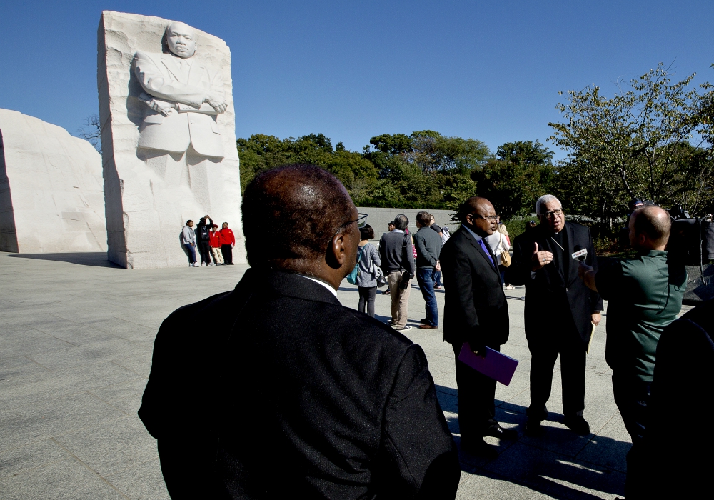 Bishop George Murry (facing camera, right), chair of the U.S. bishops' Ad Hoc Committee Against Racism, conducts an interview near the Martin Luther King Jr. Memorial in Washington Oct. 2. (CNS/Tyler Orsburn) Bishop George Murry (facing camera, right), chair of the U.S. bishops' Ad Hoc Committee Against Racism, conducts an interview near the Martin Luther King Jr. Memorial in Washington Oct. 2. (CNS/Tyler Orsburn)
