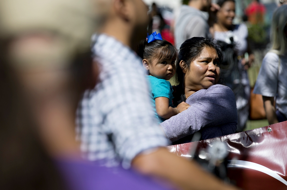 A woman holds a child during an immigration rally near the U.S. Capitol in Washington Sept. 26. (CNS/Tyler Orsburn)