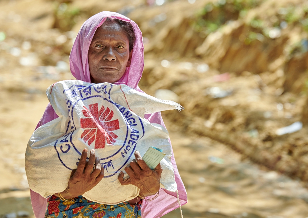 A Rohingya woman carries a bag of food provided by Caritas in the Mainerghona Refugee Camp Oct. 27 near Cox's Bazar, Bangladesh. (CNS/Paul Jeffrey) 
