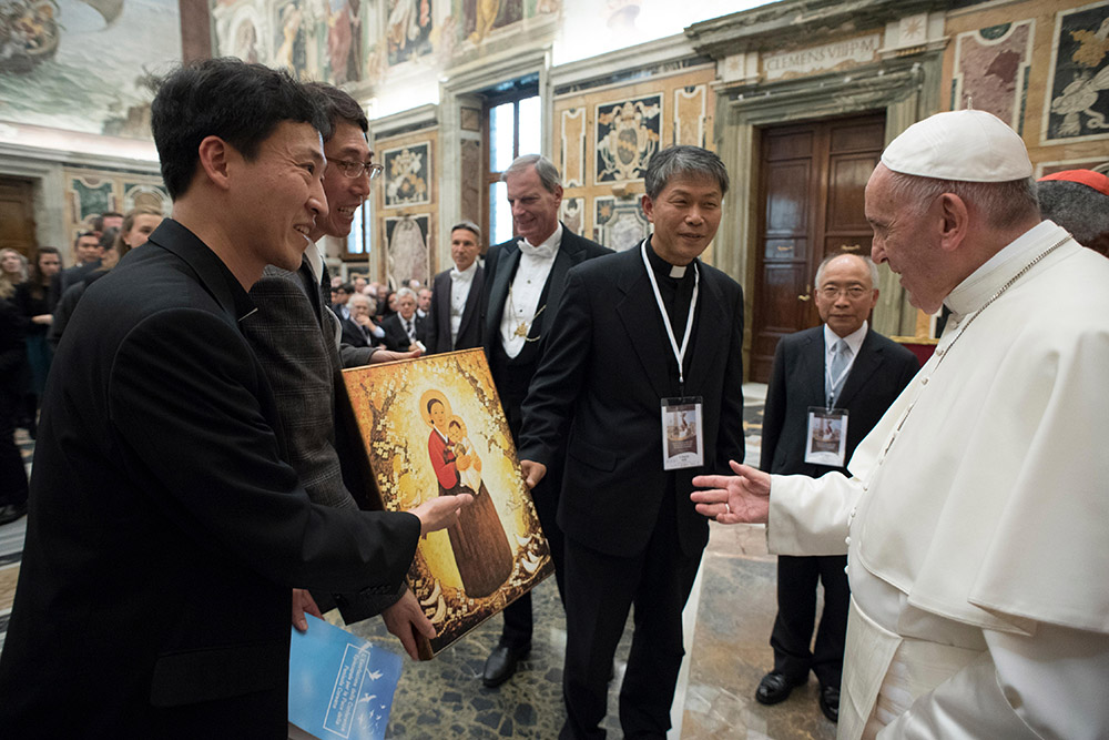 Pope Francis accepts a gift of a Marian icon as he meets people attending a conference on building a world free of nuclear weapons, at the Vatican Nov. 10, 2017. (CNS/L'Osservatore Romano)