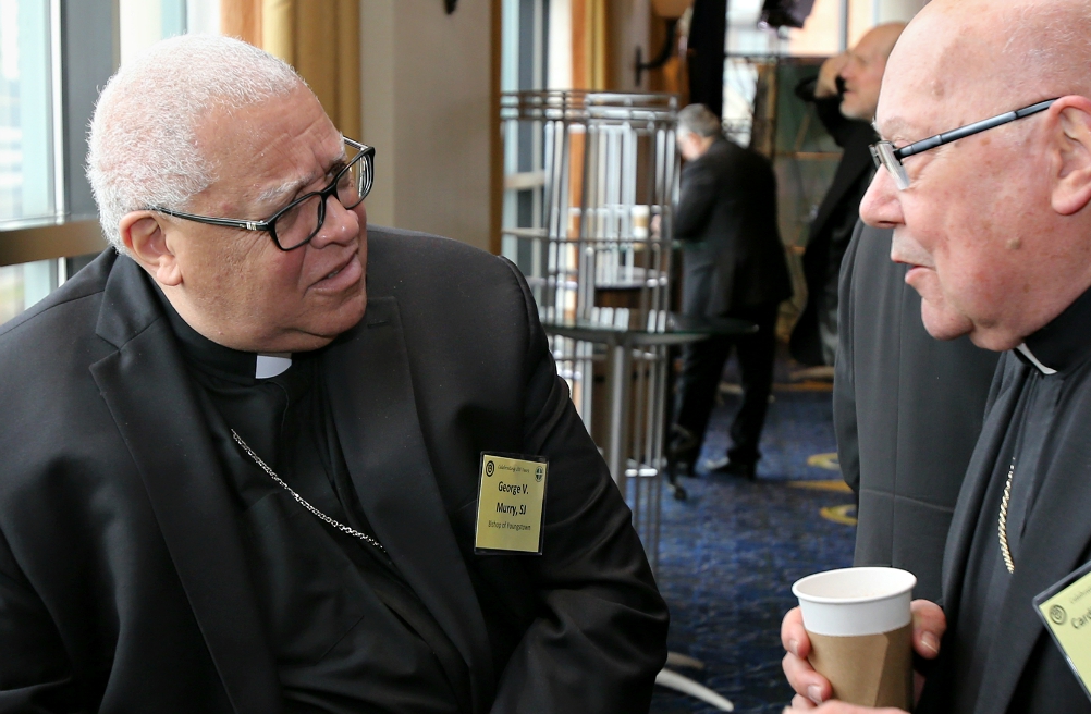Bishop George Murry, left, chair of the U.S. bishops' Ad Hoc Committee Against Racism, chats with Cardinal William Levada Nov. 14 during the U.S. bishops' fall general assembly of the U.S. Conference of Catholic Bishops in Baltimore. (CNS/Bob Roller)