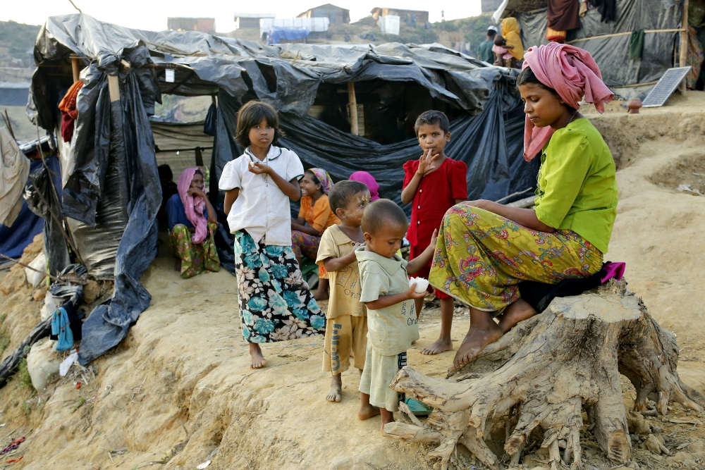 A Rohingya family sits outside their tent Nov. 20 at a refugee camp in Cox's Bazar, Bangladesh. (CNS/EPA/Abir Abdullah)
