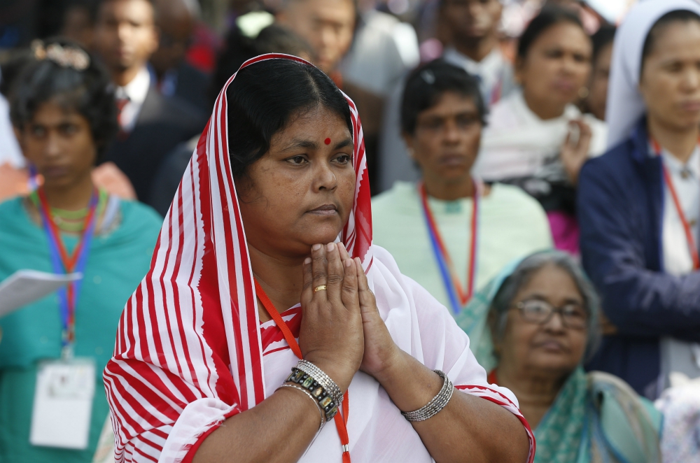 A woman prays as Pope Francis celebrates Mass and the ordination of priests in Suhrawardy Udyan park in Dhaka, Bangladesh, Dec. 1. (CNS/Paul Haring) A woman prays as Pope Francis celebrates Mass and the ordination of priests in Suhrawardy Udyan park in Dhaka, Bangladesh, Dec. 1. (CNS/Paul Haring)