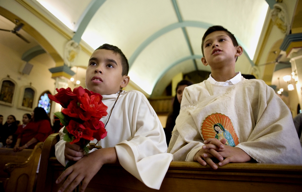 Johann Palomino, 11, and Archie Gonzalez, 10, attend a Mass celebrated in honor of the 100th anniversary of Our Lady of Guadalupe Church in San Diego Dec. 9, 2017. (CNS/David Maung)