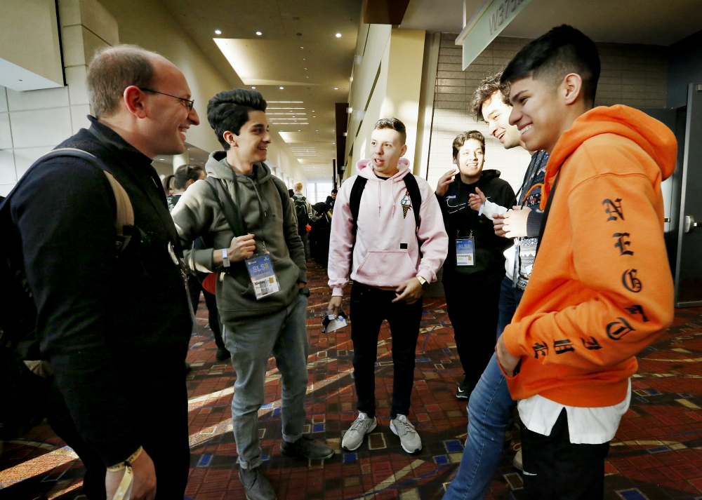 Fr. Bobby Krueger, pastor at St. Leonard Parish in Berwyn, Illinois, visits with young people Jan. 3 during a conference sponsored by the Fellowship of Catholic University Students in Chicago. (CNS/Chicago Catholic/Karen Callaway)