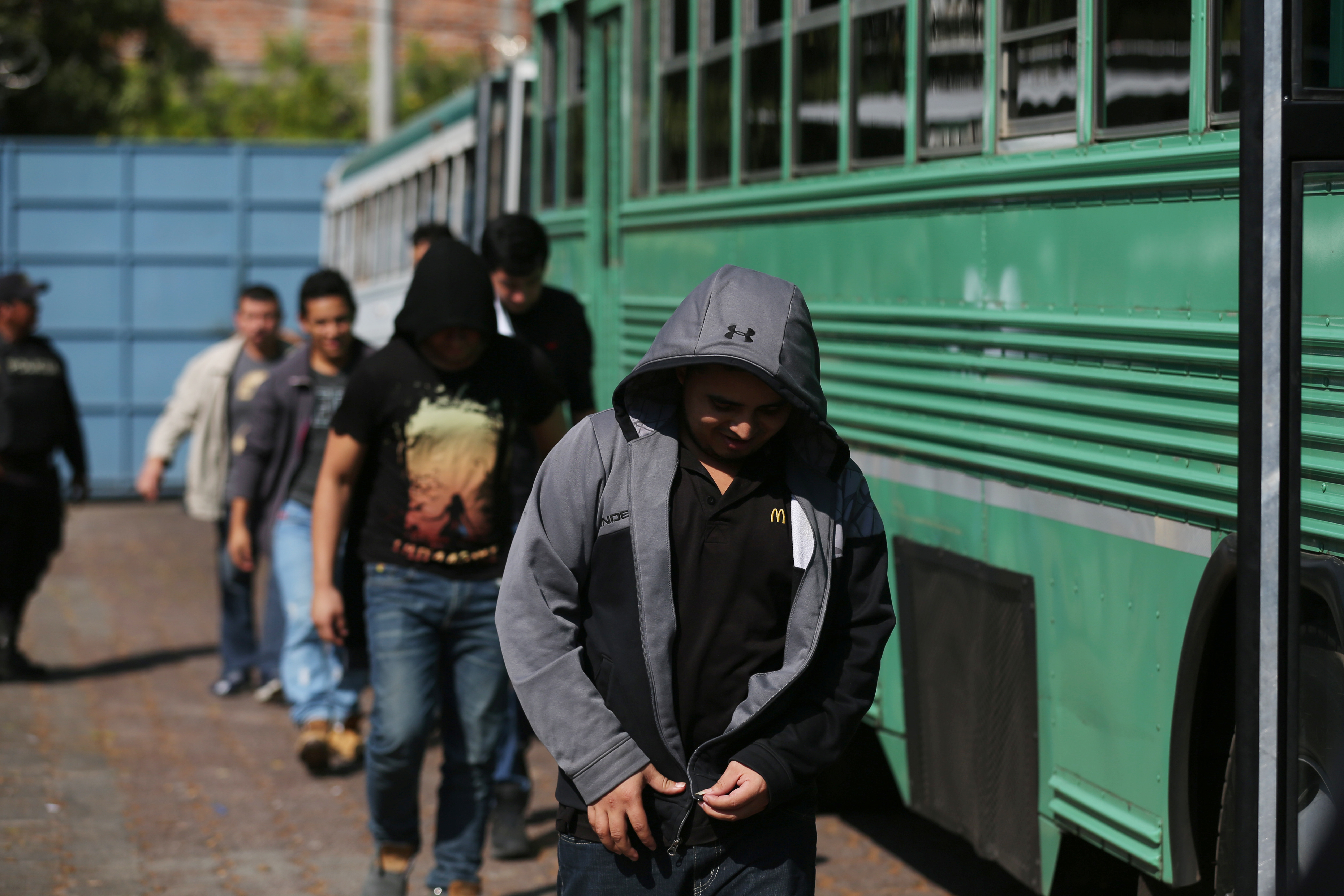 Deportees get off a bus at an immigration facility Jan. 11 after a flight arrived in San Salvador, El Salvador, with immigrants who were in the U.S. without documents. U.N. officials said Jan. 12 that U.S. President Donald Trump's reported use of an exple