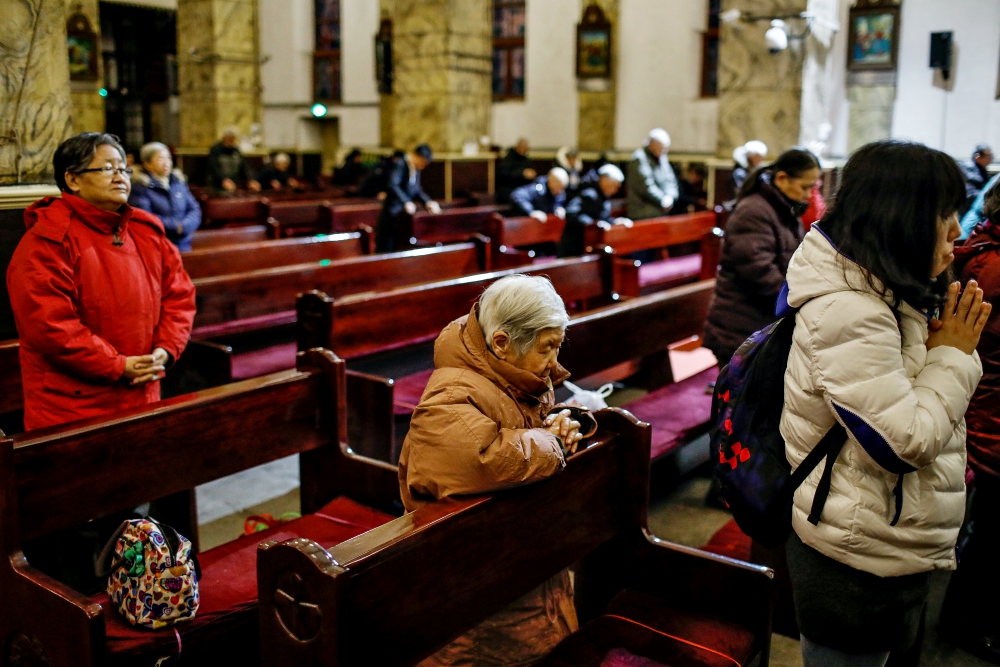 People pray during morning Mass Jan. 30 in the Cathedral of the Immaculate Conception in Beijing. (CNS/EPA/Roman Pilipey) 