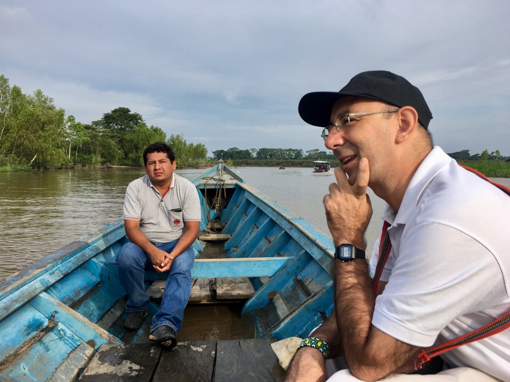 Bishop David Martínez de Aguirre Guinea travels in a boat Feb. 21 as he visits the indigenous community of Arazaire, Peru, with Caritas workers. (CNS/Stringer) 