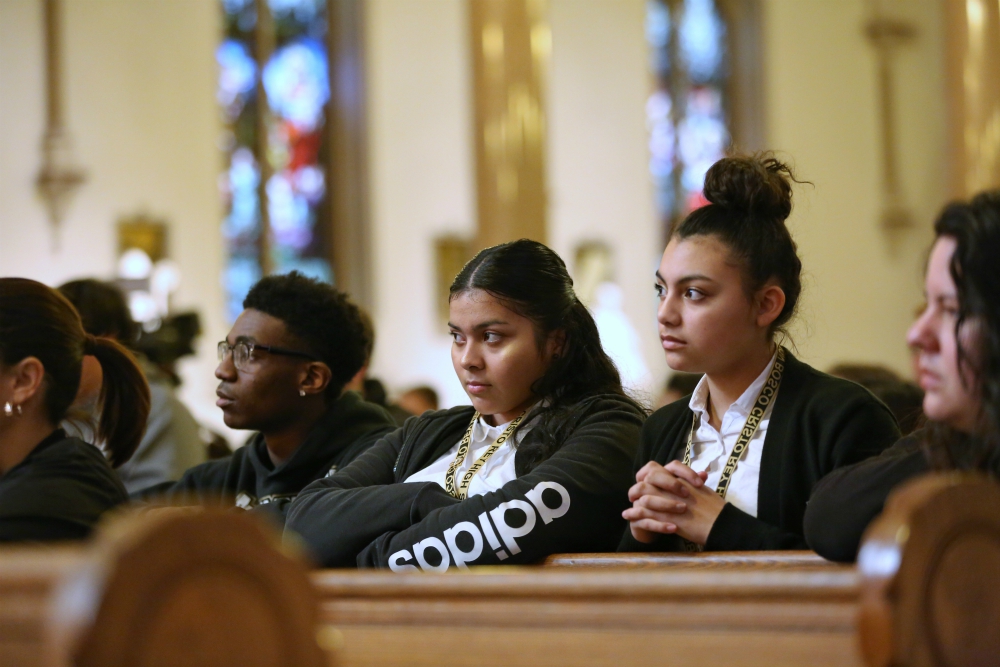 Stephon Wheaton, Roxanna Villalta and Gabi Barrera, students at Don Bosco Cristo Rey High School in Takoma Park, Maryland, pray during a March 24 Mass at St. Patrick Catholic Church in Washington. (CNS/Catholic Standard/Jaclyn Lippelmann)