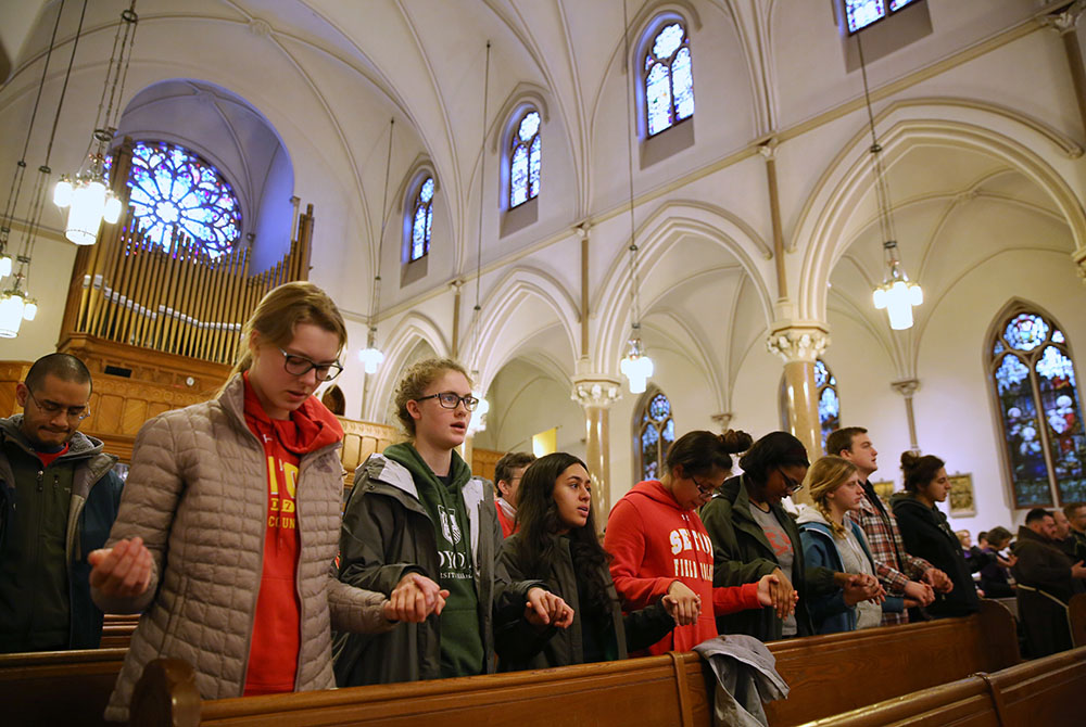 Students from Elizabeth Seton High School in Bladensburg, Maryland, pray during a March 24, 2018 Mass at St. Patrick Catholic Church in Washington. (CNS/Jaclyn Lippelmann, Catholic Standard)