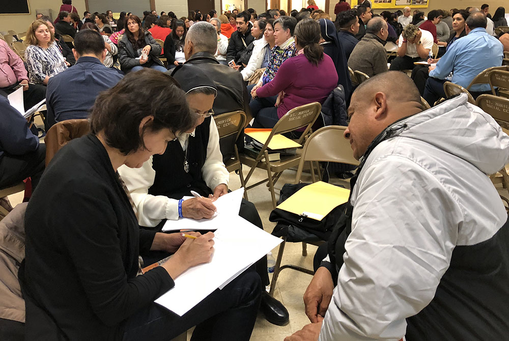 A woman religious and other delegates share information during a regional encuentro in the Diocese of Rockford, Illinois, April 28, 2018, at St. Monica Parish in Carpentersville. (CNS/El Observador/Margarita Mendoza)