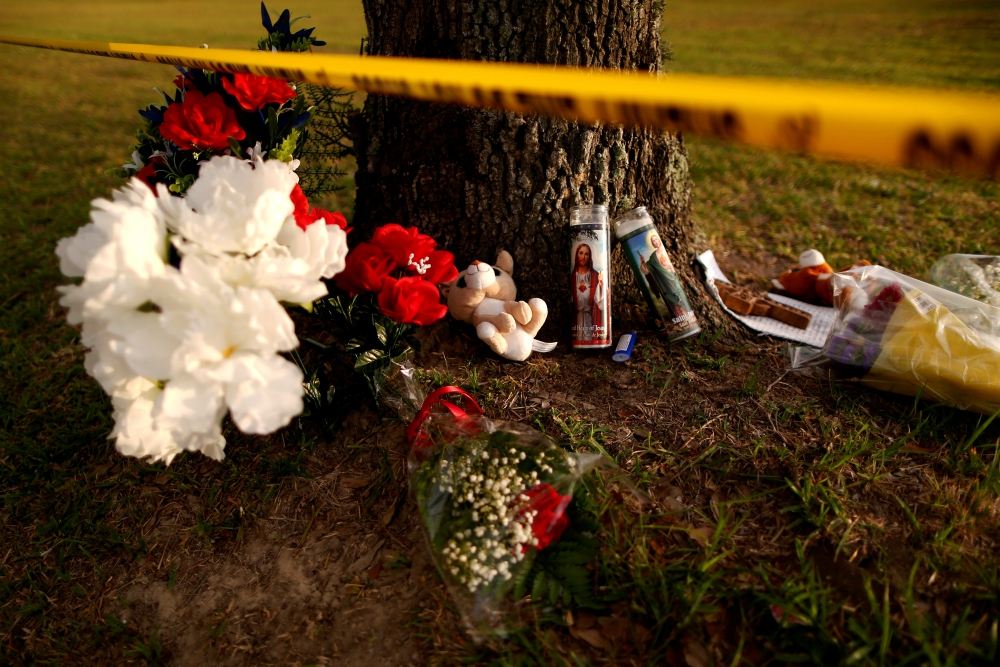 Candles with images of Christ and other items are seen May 20 at a makeshift memorial in memory of the victims killed in a shooting at the Santa Fe High School in Texas. (CNS/Reuters/Jonathan Bachman)