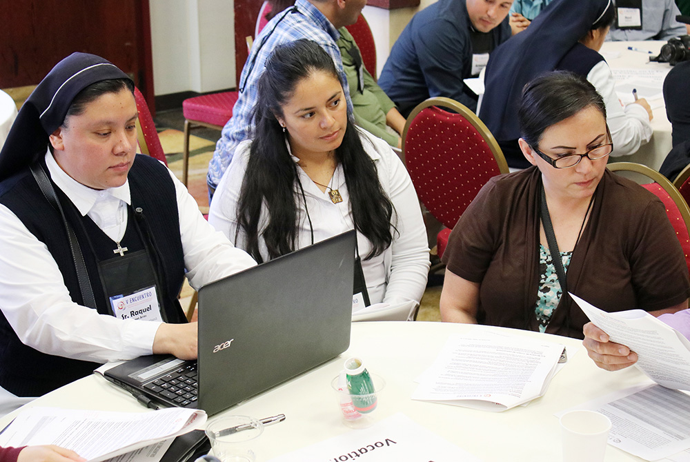 Sr. Raquel De Leon types notes as Victoria Rodriguez of the Diocese of Boise, Idaho, and Maria Elena Ruiz of the Archdiocese of Portland, Oregon, listen to speakers June 22, 2018, at the Region XII gathering of V Encuentro in Portland, Oregon. (CNS) Sr. Raquel De Leon types notes as Victoria Rodriguez of the Diocese of Boise, Idaho, and Maria Elena Ruiz of the Archdiocese of Portland, Oregon, listen to speakers June 22, 2018, at the Region XII gathering of V Encuentro in Portland, Oregon. (CNS)