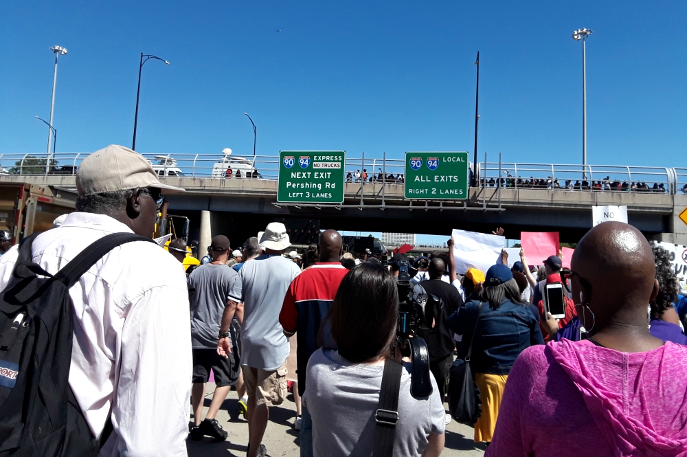 Thousands of people led by Fr. Michael Pfleger of St. Sabina Catholic Parish in Chicago, the Rev. Jesse Jackson and the ChicagoStrong student group shut down part of a major highway in Chicago July 7 to protest gun violence. (Laurette Hasbrook)