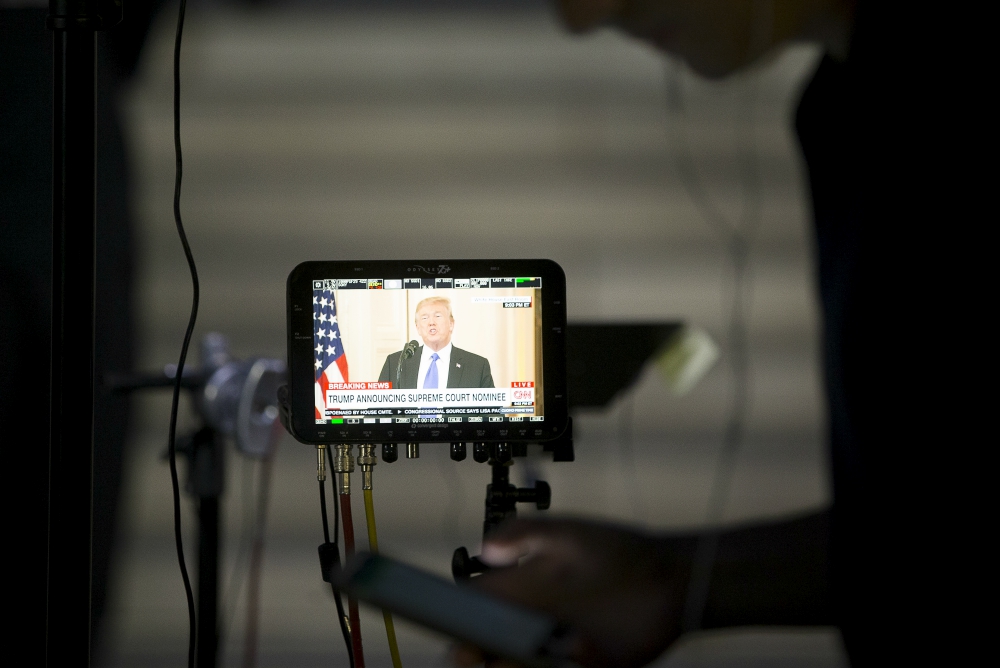 President Donald Trump is seen on a broadcast monitor outside the U.S. Supreme Court in Washington July 9. (CNS/Tyler Orsburn)