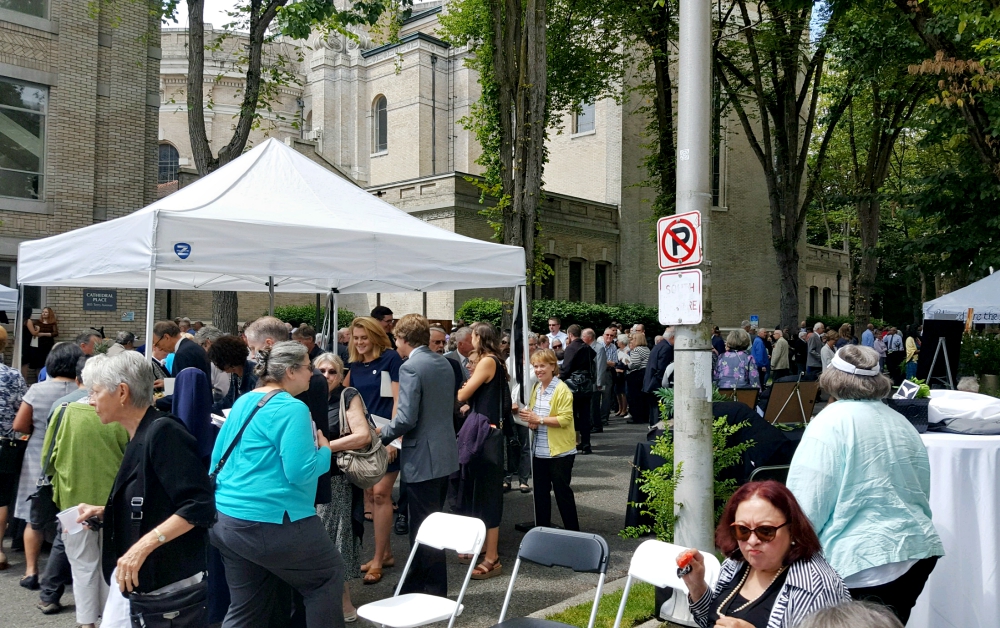 Hundreds of persons who attended the Aug. 1 funeral for Seattle's retired Archbishop Raymond Hunthausen at St. James Cathedral join a following reception on a blocked-off city street behind the church. (NCR photo/Dan Morris-Young)