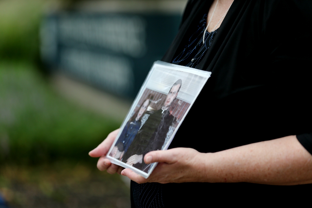 Becky Ianni holds a photo of herself as a child with a priest Aug. 21 outside the headquarters of U.S. Conference of Catholic Bishops in Washington. Ianni says she was abused by the priest in the photo. (CNS/Bob Roller) Becky Ianni holds a photo of herself as a child with a priest Aug. 21 outside the headquarters of U.S. Conference of Catholic Bishops in Washington. Ianni says she was abused by the priest in the photo. (CNS/Bob Roller)