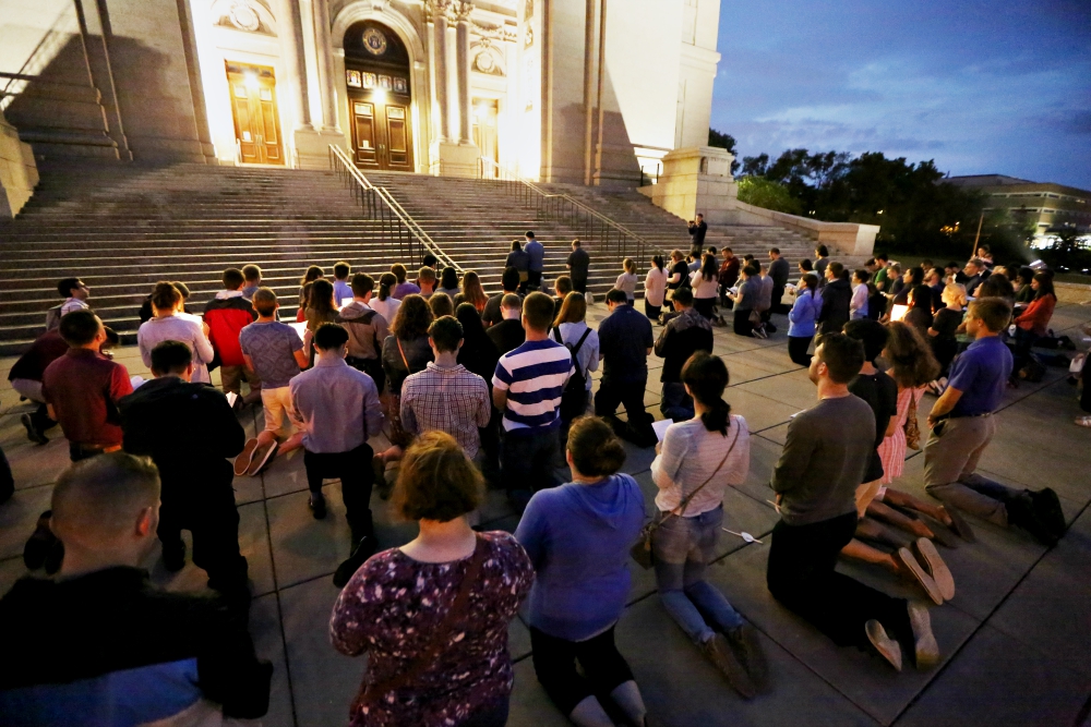 About 120 young adults kneel and pray at the Cathedral of St. Paul, Minnesota, Aug. 20 during a vigil called "Evening Prayer for the Survivors of Clerical Abuse and the Healing of the Church." (CNS/The Catholic Spirit/Dave Hrbacek)